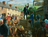 painting of Dan Jones holding Book of Mormon, standing on stone wall preaching to people