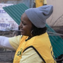 A woman does service for neighbors after a natural disaster