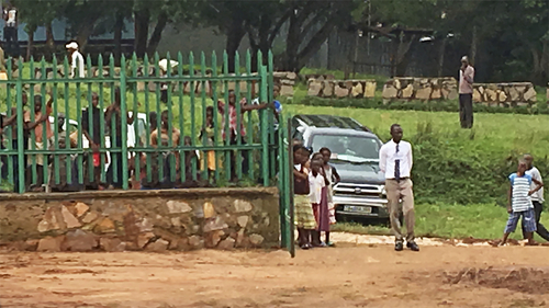 Children outside fence