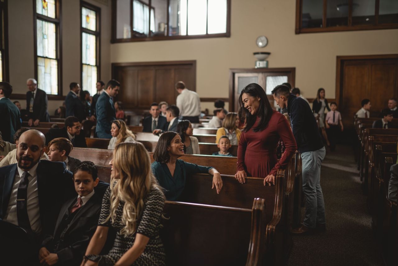 Church members greet one another during a Sunday service enjoying the blessings of Jesus Christ