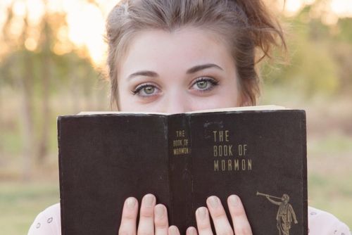 Young adult reading the Book of Mormon