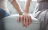 man and woman holding hands while sitting on couch