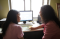 women sitting in front of computer