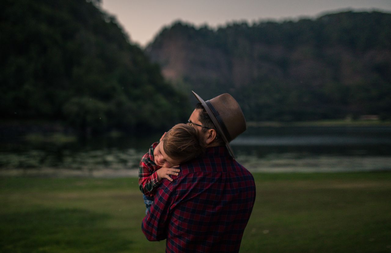 A father holds his newborn baby