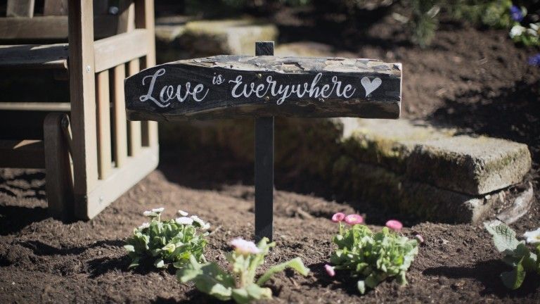 Love is everywhere on a sign posted in a garden