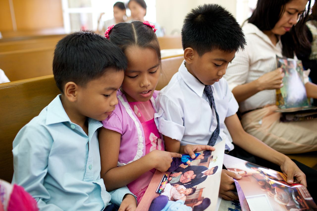 Children sit together on a chapel pew learning about the gospel of Jesus Christ