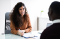 Young Woman Interviewing a Young Man