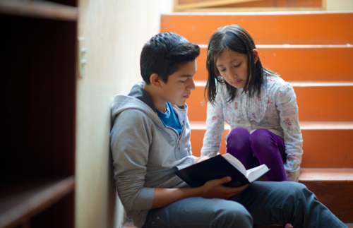 Ein Junge liest im Buch Mormon