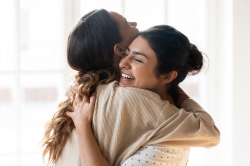 two women hugging each other