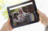 tablet with image of people cutting ribbon