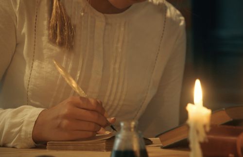young woman writing in journal