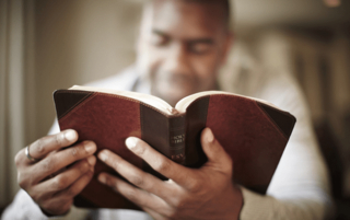 A man studies the Ten Commandments in the Bible