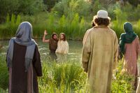 Jesus Christ is baptized in the river Jordan by John the Baptist